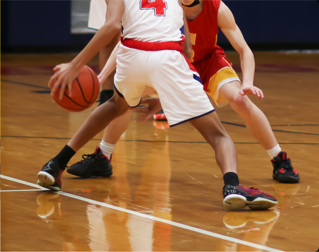 chasingdreams_cropped A high school basketball player dribbles the ball in front of a defender