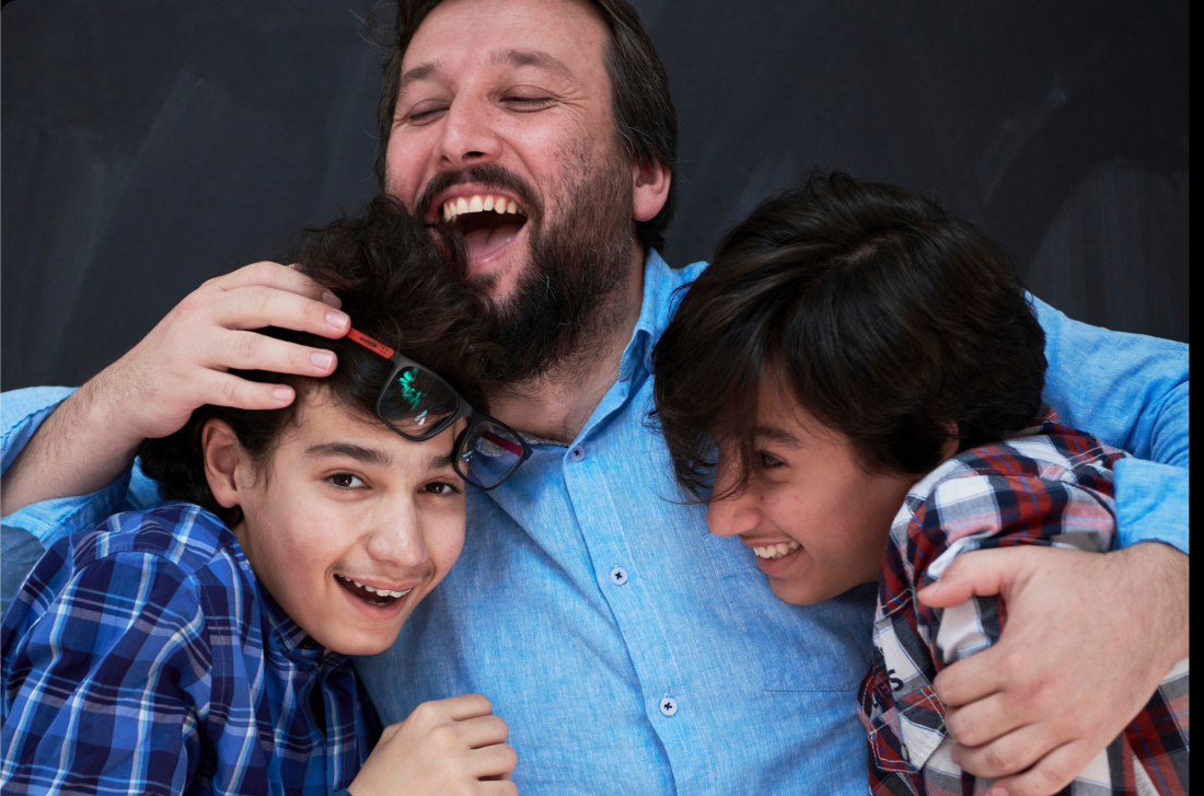 familyactivities_short A smiling father hugs his two sons