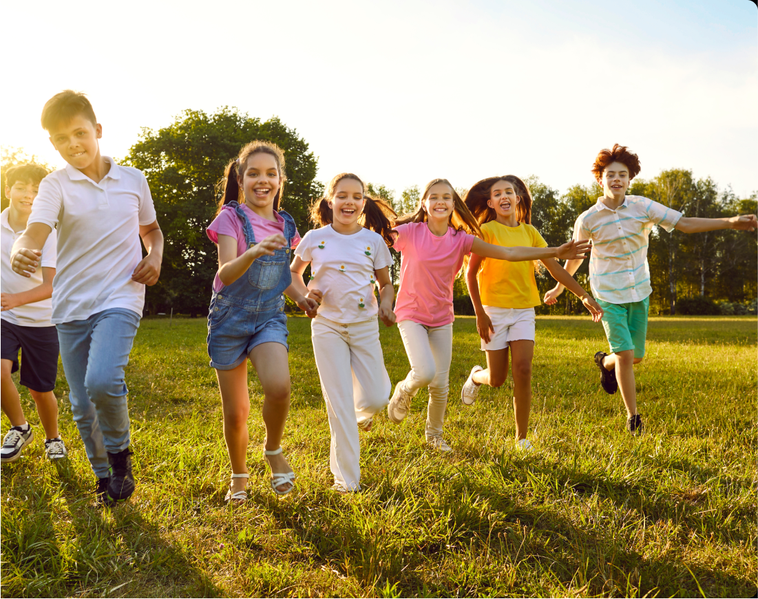 goalgetters A group of seven joyful youths run on green grass in the summer