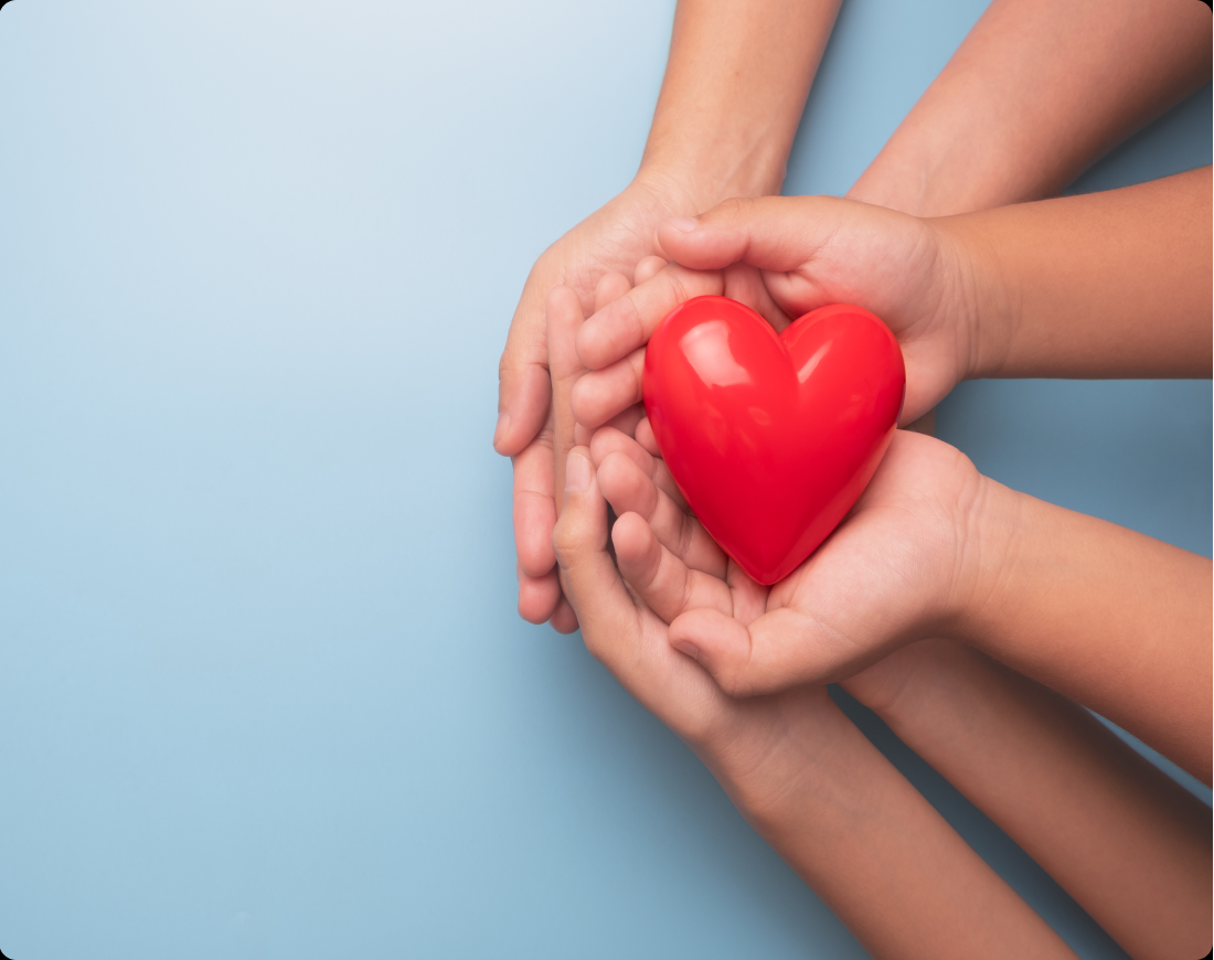 support_empoweryouthfutures_stock Several youths hold their hands open with a heart in the middle